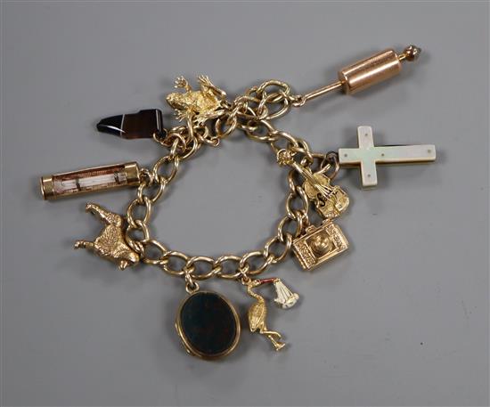 A 9ct gold charm bracelet, hung with ten assorted charms including a chalcedony set mourning locket.